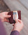 High quality lifestyle image of the slim business card leather holder in Italian reddish brown