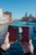 High quality open lifestyle image of the passport leather sleeve in reddish brown