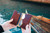 High quality open lifestyle image of the passport leather sleeve in reddish brown