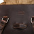 This is the open side view of the double handle purse in dark brown
