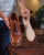 High quality wooden shoe tree held alongside a brown leather wingtip shoe - Saddleback Leather