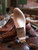 High quality wooden shoe tree bottom sole profile beside brown leather wingtip shoes - Saddleback Leather
