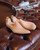 High quality Italian wooden shoe trees positioned together on brown leather bench - Saddleback Leather