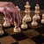 High quality these are chess pieces being moved on a leather travel chess set.