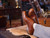 High quality natural tan full grain leather wing tip shoes upright on a fur-covered trunk with accessories - Saddleback Leather