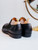 High quality black full grain leather wing tip shoes rear three-quarter view showing heel counter and back seam - Saddleback Leather
