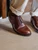 High quality overhead close-up of dark oak full grain leather toe cap shoe brogue detail and vamp - Saddleback Leather