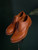 High quality tan full grain leather toe cap shoes elevated studio portrait on stand with dark green background - Saddleback Leather