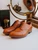 High quality tan full grain leather toe cap shoes studio three-quarter front view with brass vanity mirror - Saddleback Leather