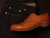 High quality tan full grain leather toe cap shoe side profile flat lay with dark raw denim jeans - Saddleback Leather