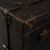 High quality leather trunk that will be a vintage antique one day in a museum. This is the corner. It is a dark brown steamer trunk that was old time luggage back in the day on trains and ships.