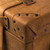 High quality leather trunk that will be a vintage antique one day in a museum. This is the corner. It is a tan brown steamer trunk that was old time luggage back in the day on trains and ships.