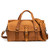 This is a tan brown leather duffle bag that has three straps to close it and has two round handles from the front.