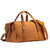 This is a tan brown leather duffle bag that has three straps to close it and has two round handles from the back side.