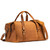 High quality tan brown leather duffle bag that has three straps to close it and has two round handles from the back side.
