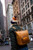 High quality this tan leather woman's backpack is shown on a model