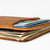 High quality tan brown leather wallet laying down at the end.