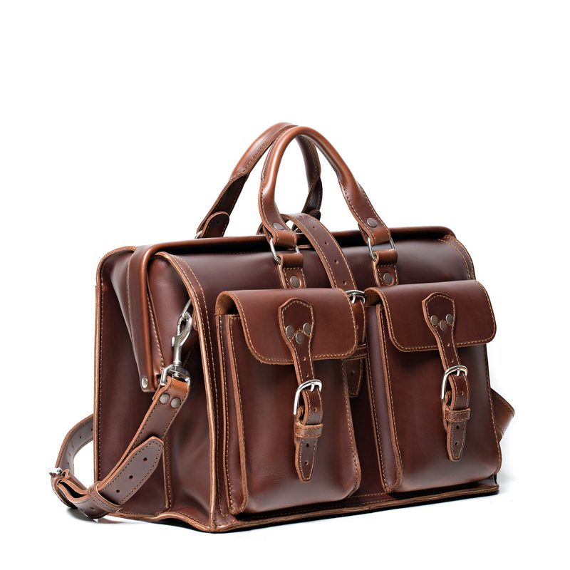 This dark brown leather briefcase is wide open and full of laptops and other things for lawyers.