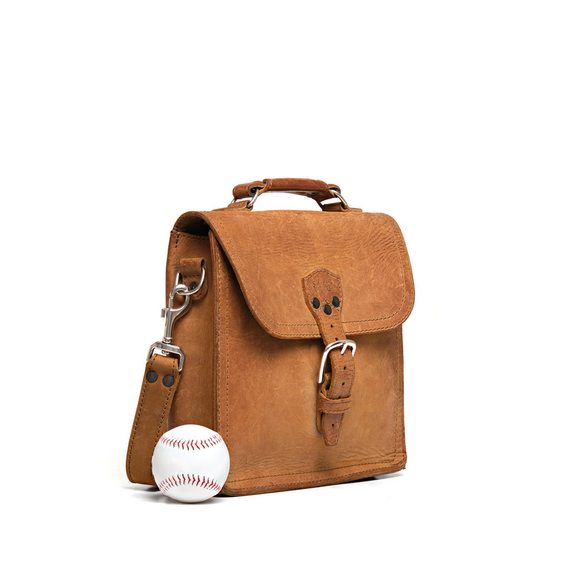 High quality side view of the leather satchel with baseball