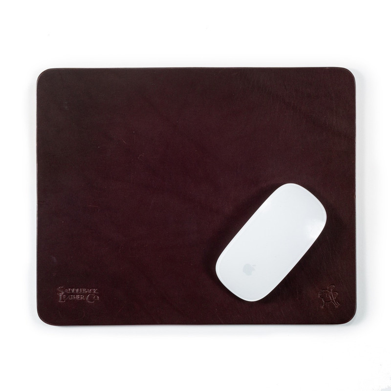 This is a reddish brown leather normal mouse pad with a mouse on it.