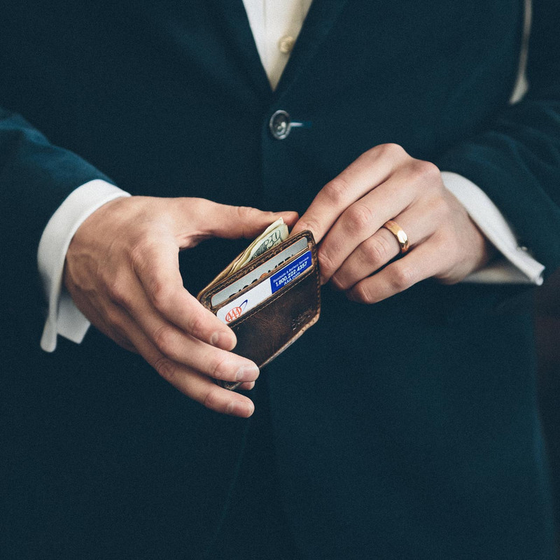 High quality man holding a thin leather wallet.