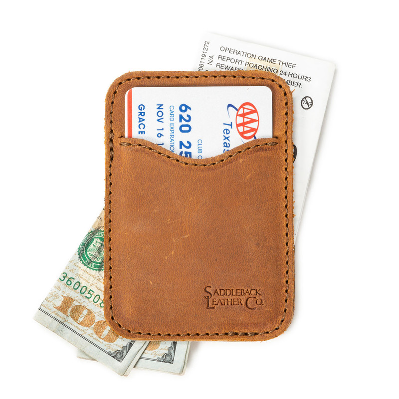 High quality tan brown leather wallet open with cash sticking out both ends.