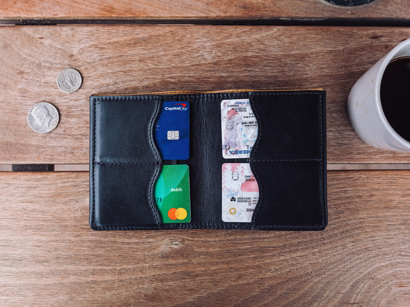High quality lifestyle image of the Silverback Large Bifold leather Wallet in black