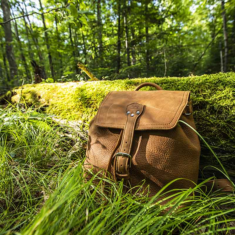 The 12" Leather Drawstring Backpack is simple and functional, with a wide open top and pigskin-lined back, as well as a laptop pocket that fits a 13” Macbook.