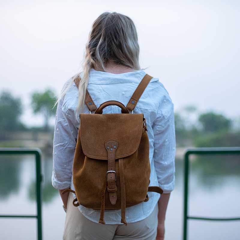 The 12" Leather Drawstring Backpack is simple and functional, with a wide open top and pigskin-lined back, as well as a laptop pocket that fits a 13” Macbook.
