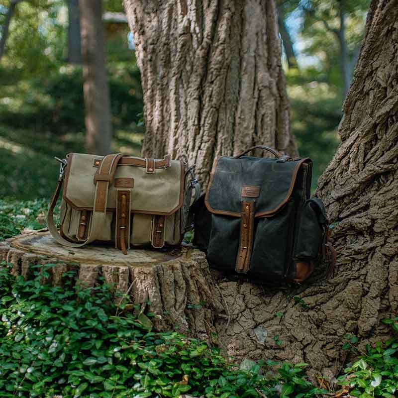 The five-pocket canvas backpack includes two side pockets and two front pockets, all of which are hand-pounded with copper rivets. The main compartment is lined with full-grain tumbled leather.