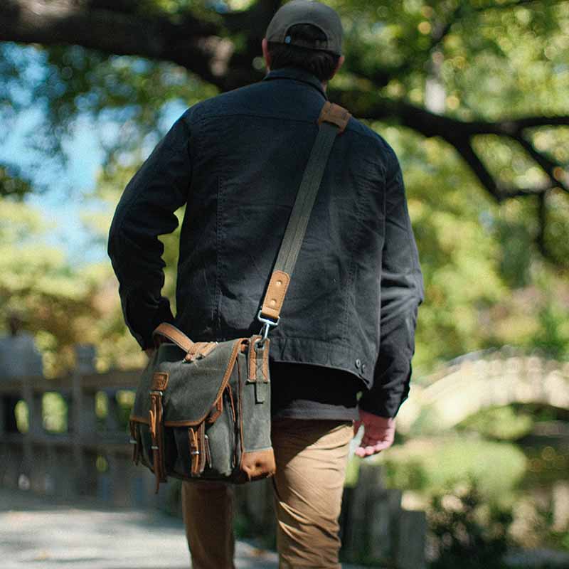 The Front Pocket Weatherproof Canvas Messenger Bag is a high-quality, durable bag made with waxed canvas and full-grain tumbled leather.