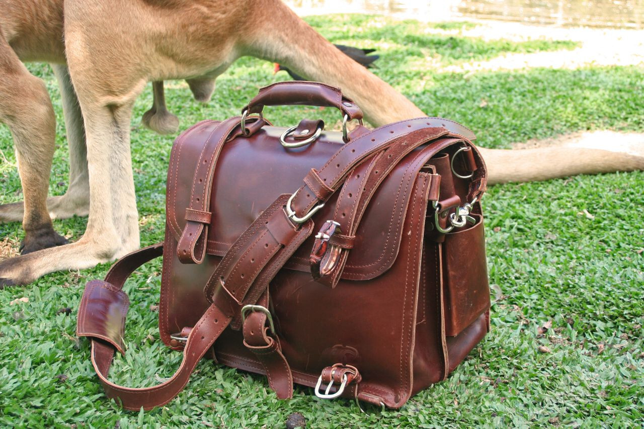 Leather briefcase with removable straps, in front of a male kangaroo.