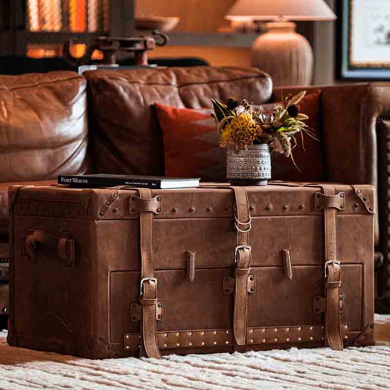 Our leather trunk is made with full grain leather, pigskin lining, and UV resistant thread for durability. It features custom hardware and a front door for easy access.