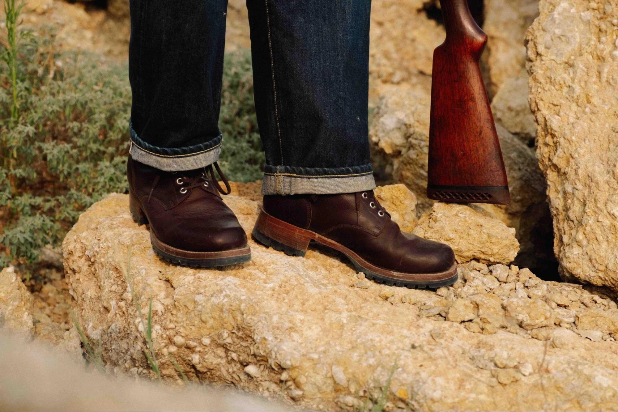 Dark Coffee Brown Huntsman Boots worn on rocky ground