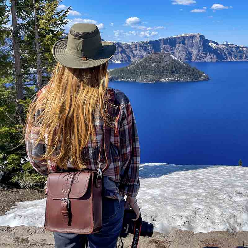 A leather satchel is a bag made of leather, typically with a single strap that goes over the shoulder, used for carrying books or other items.