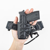 PHLster Enigma Micro in a person's hand, showing the back of the holster.