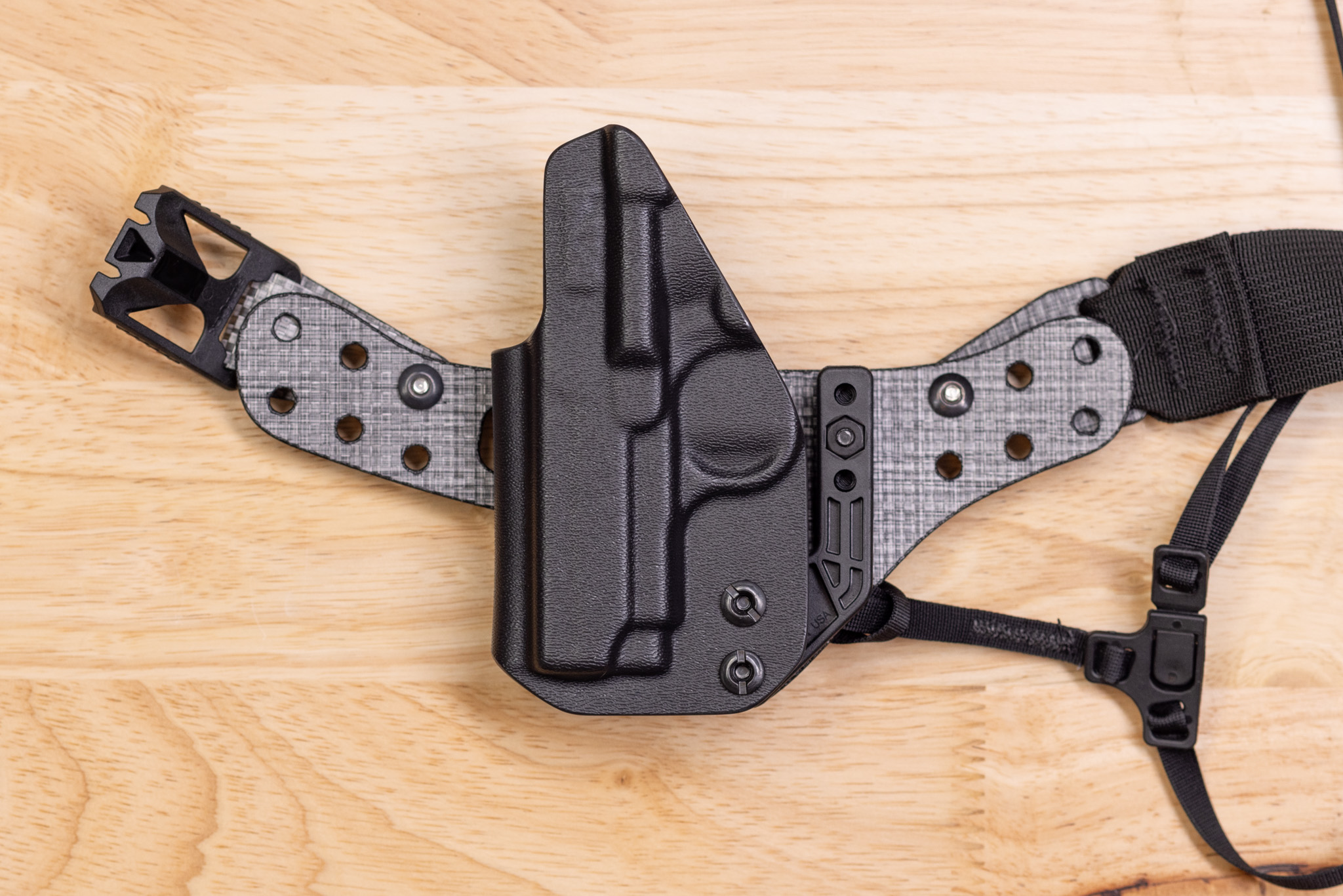 Photo showing how the Enigma faceplate and holster fit around a tiny gun.