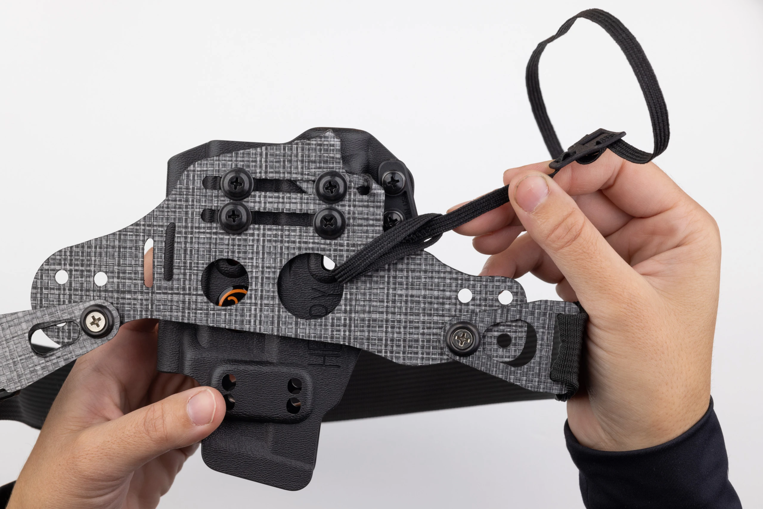 Photo showing how folded leg leash tab on Gen 1 Enigma doesn't hang down below the holster.