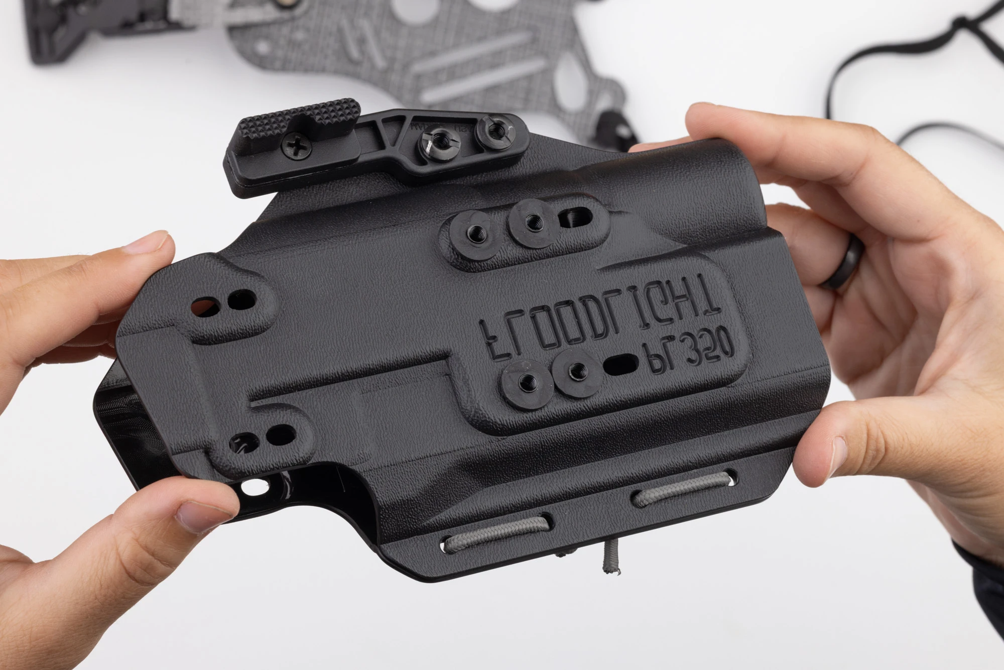 Photo of screw posts and rubber washers installed on kydex holster.