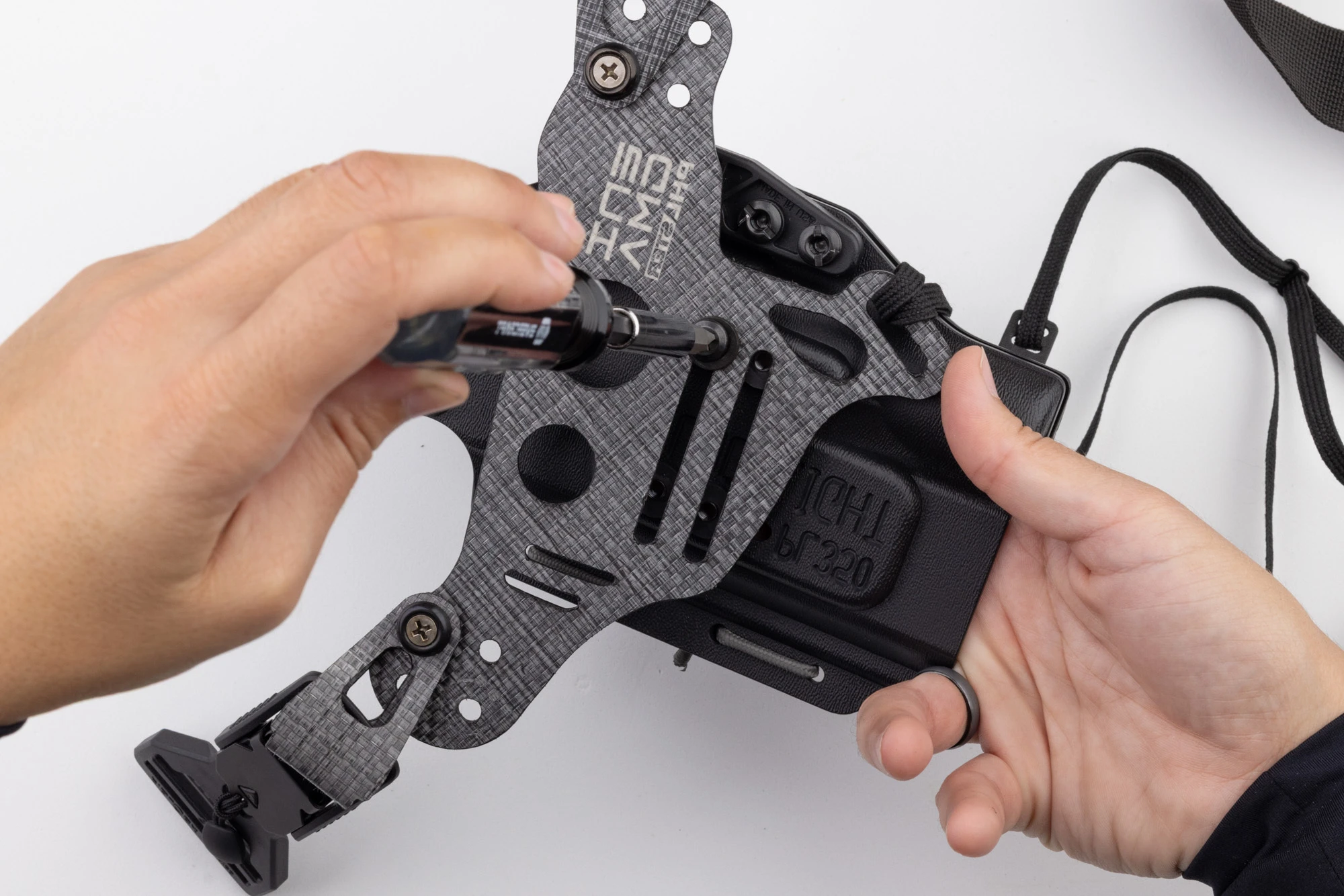 Photo of screwdriver tightening screw on Light Bearing Enigma.