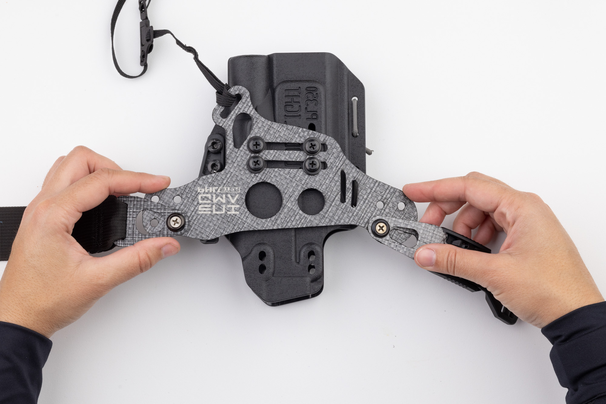 Photo showing how to check Enigma faceplate and holster for straightness.
