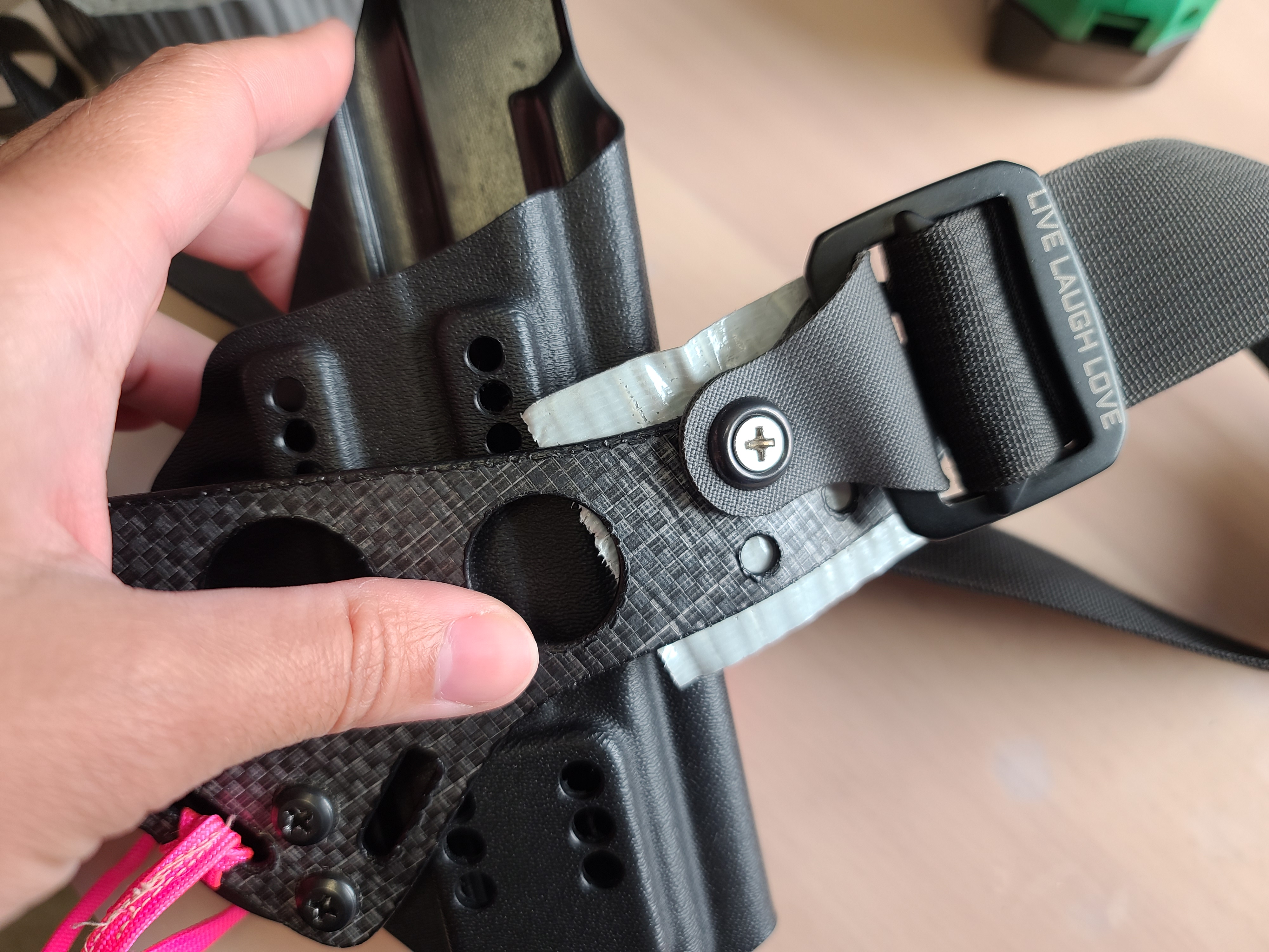 Apply tape to back of faceplate, then press down against your rubber band and table.