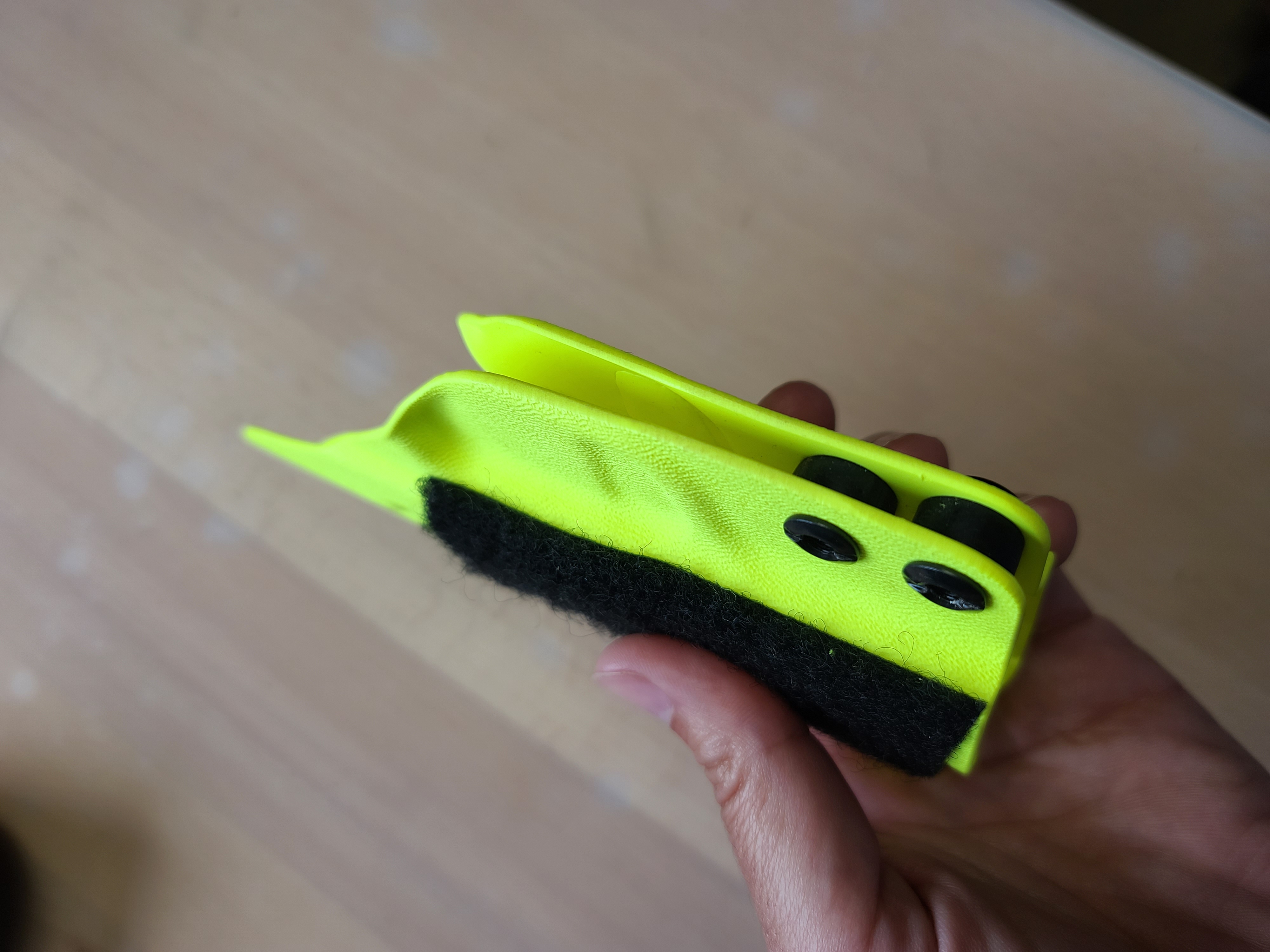 Different angle - photo of adjustable retention kydex holster with rubber retention washers between the two halves.