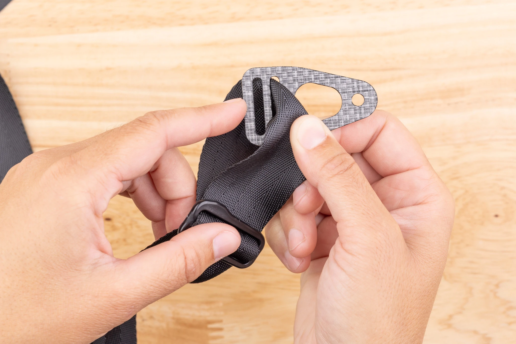 Photo of the Enigma belt end and Tri-Lock held in both hands.