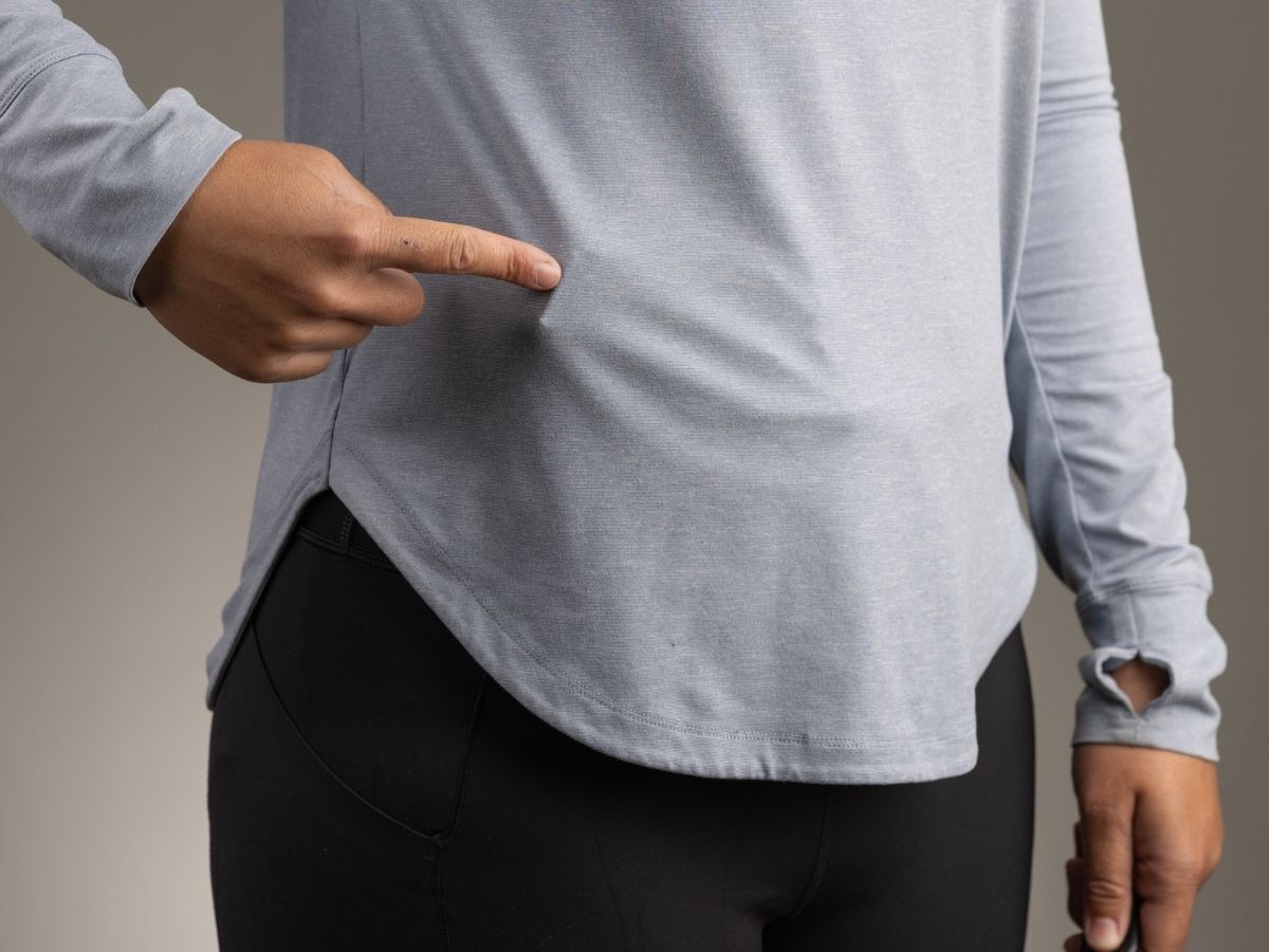 Gun printing visibly through a thin athletic shirt.