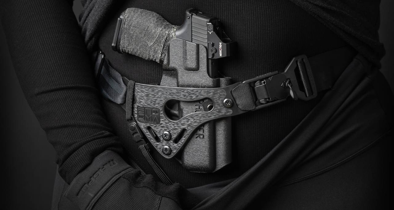 A person wearing a PHLster Enigma holster with a Sig Sauer P365XL, featuring the text Enigma V2: The next evolution of excellence.