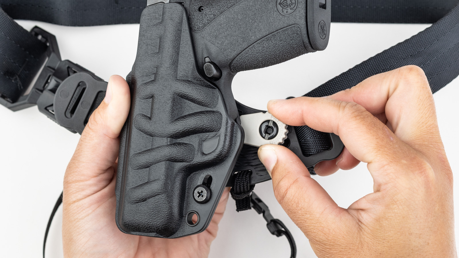 PHLster Enigma Micro CamWing adjustment feature &mdash; slide and rotate, faceplate presses in on belt tension