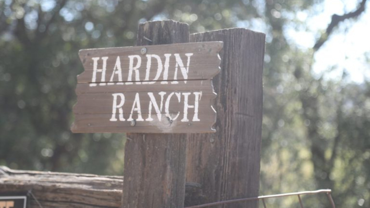 Wooden Hardin Ranch sign among trees