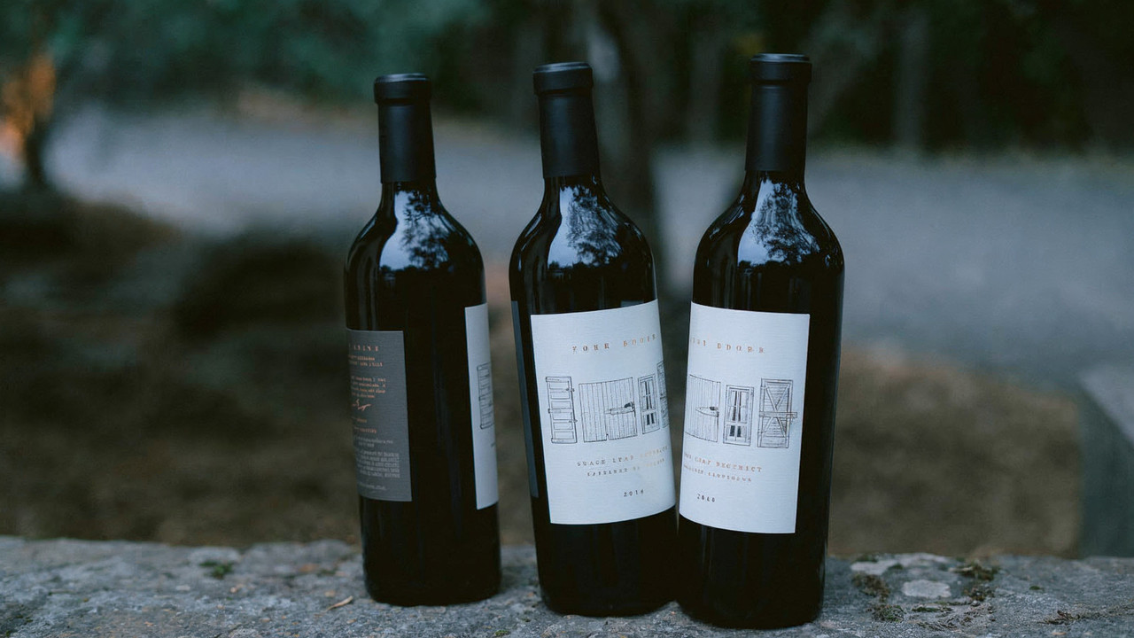 Three Four Doors Cabernet bottles arranged on a stone wall