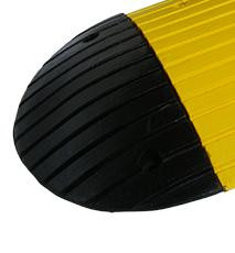 INTERLOCKING SPEED RAMP 70mm BLK END CAP, close-up of the black rubber end cap with yellow reflective strip for safety and interlocking design for speed ramps.